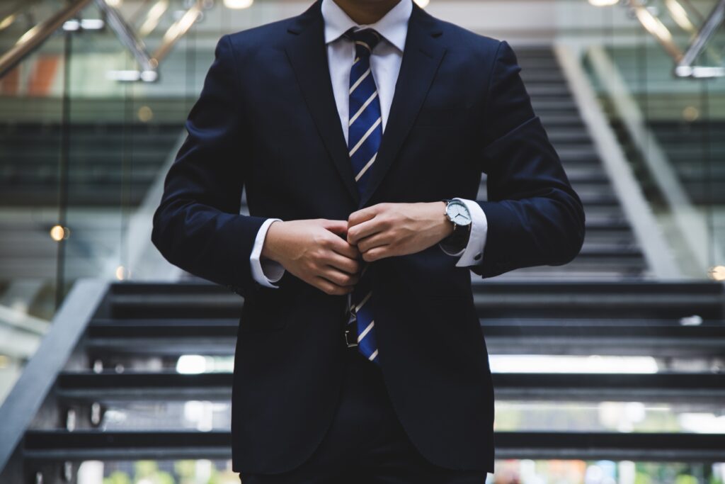 Successful investor wearing suit and watch.