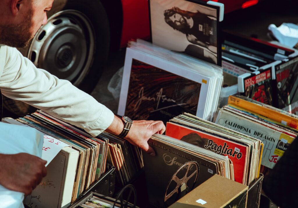 Ultra-high-net-worth investor sifting through record collection.
