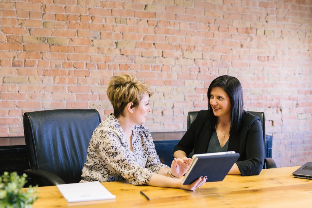 Financial advisor gaining trust with happy client after tracking alternative investments.