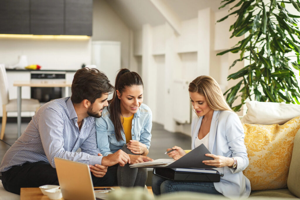 Financial advisor reviewing positive results to their two clients, after allocating to alternative investments.