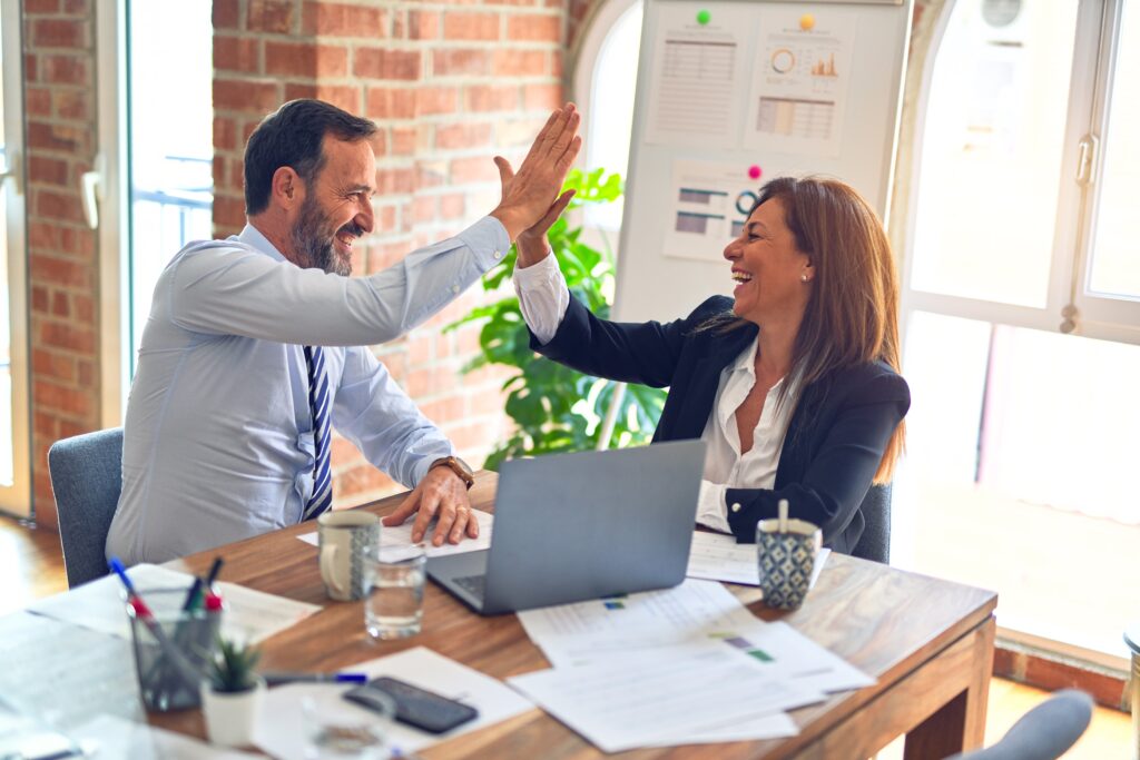 Financial advisor helping happy client thrive during a recession.